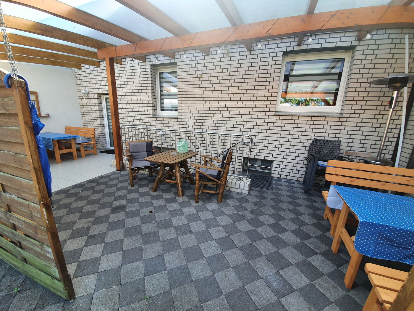 Covered terrace with seating and barbecue area